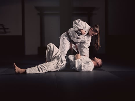 Krav Maga trainer teaching man to defend from gun photo