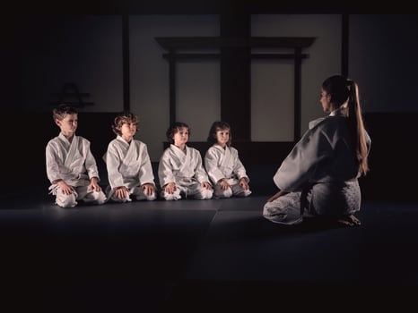 Krav Maga trainer with group of kids in studio photo
