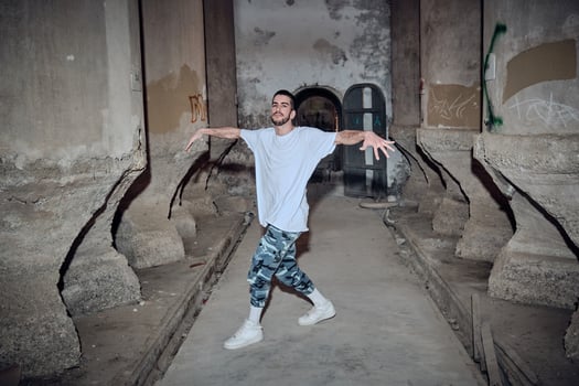 Confident man break dancing in desolated building photo