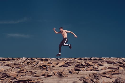 Active sportsman running and jumping on rooftop photo