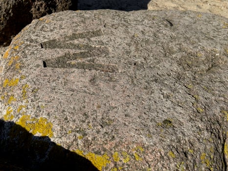 Textured Rock with Carved Letter M photo