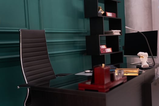 High-tech and luxurious office of the director of the company. which has a modern wooden table and an armchair photo