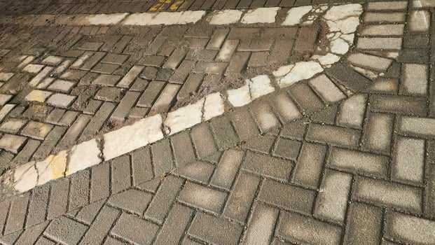 Paving slabs of different shapes and sizes on the street. photo