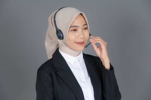Young Female Customer Service Representative Agent in a Hijab Smiling Background photo