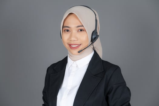 Young Female Customer Service Representative Agent in a Hijab Smiling photo