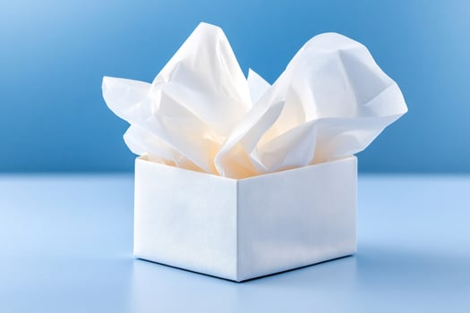 White open gift box with tissue paper on blue background photo