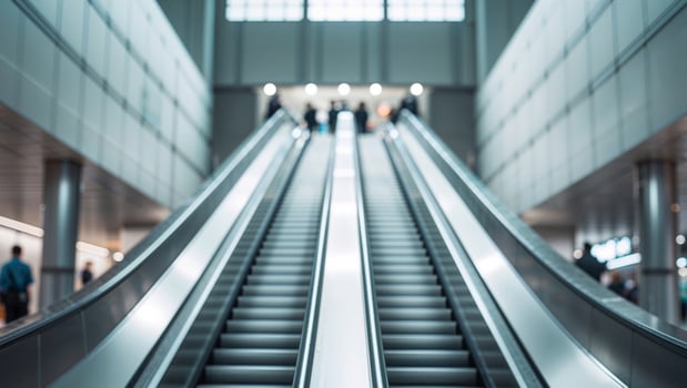 A modern escalator leads upwards in a public transit station photo