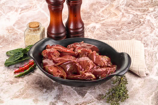 A bowl of meat and spices on a marble counter photo