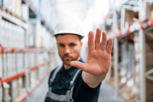 Stop here. No pass. Employee in uniform is working in the storage at daytime photo