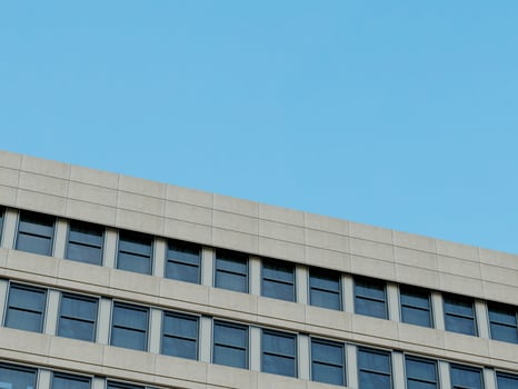 Contemporary architecture with a clean, minimalistic corner and blue sky. photo