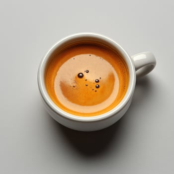 A cup of coffee with a small amount of liquid photo