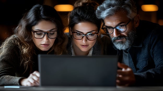 Asian business executive sharing screen from laptop, colleagues focused in a well-lit office photo