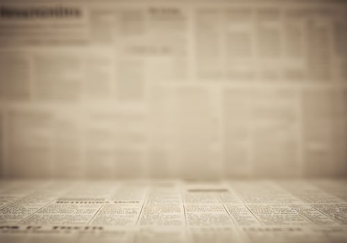 A Table of News Blurred Headlines and In-Focus Detail photo
