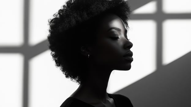 Silhouette of african female in dramatic lighting photo