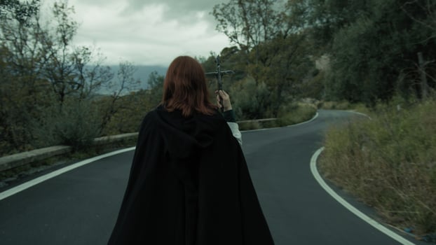 Religious Woman Walks In Street Esoteric Procession With Jesus Crucifix In Hand photo