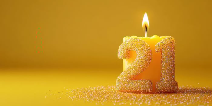 Bright yellow candle with sparkling number 21 to celebrate a special birthday occasion photo