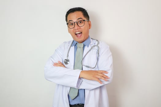 Professional good-looking asian doctor, medical worker in glasses and scrubs, cross arms and smiling photo