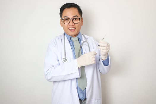 Portrait young asian doctor hold syringe needle insulin in room at hospital, medical and insurance concept. photo