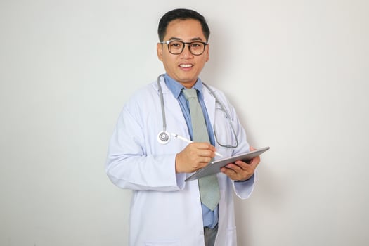 Doctor with tablet isolated on white photo