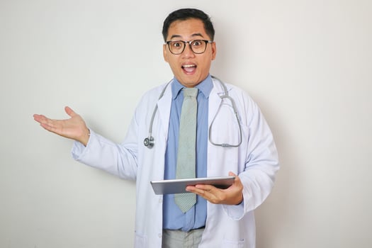 Asian doctor with tablet showing confused expression with hands open photo