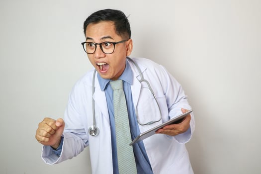 Asian doctor moving forward with tablet on hand photo