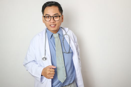Happy asian man, doctor and arms crossed in confidence of healthcare consultant at the office. Portrait of confident and male person or medical professional ready for health consultation or advice photo