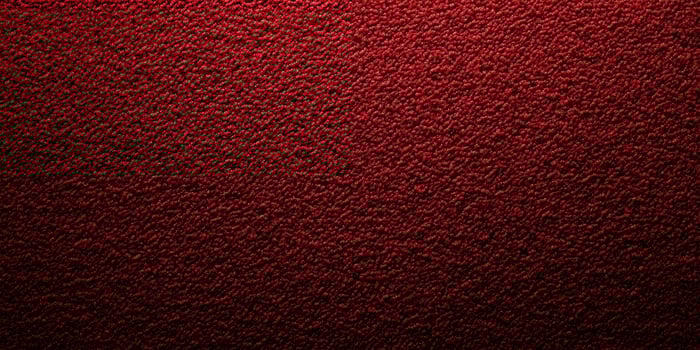 Textured background in rich red color creates a warm and inviting atmosphere perfect for design projects photo