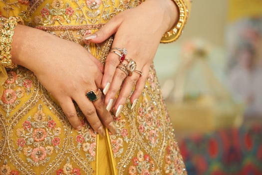Elegant hands adorned with intricate rings and beautiful embroidery photo