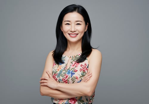 An asian woman in a floral top smiling photo