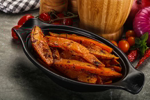 A black dish with some vegetables and spices photo
