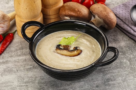 A bowl of soup with mushrooms and vegetables photo
