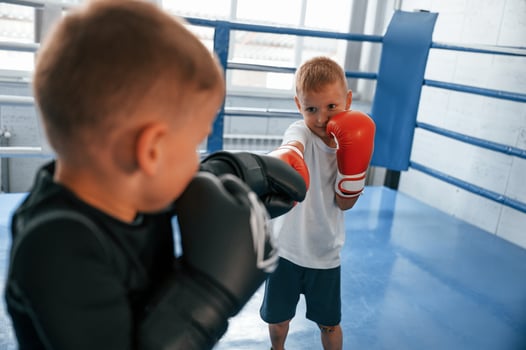 Fighting on the ring.. Boys training boxing in the gym together photo