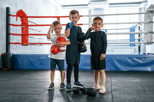 Standing and posing for a camera. Boys training boxing in the gym togethe.r photo