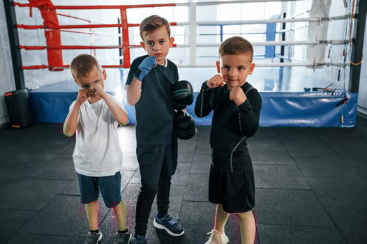 Standing and posing for a camera. Boys training boxing in the gym together. photo
