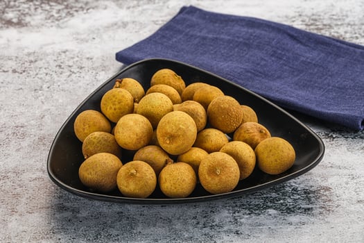 A bowl of kiwis on a table photo