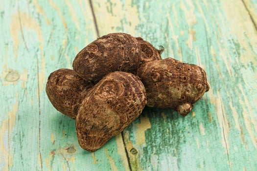 A pile of brown nuts on a wooden table photo