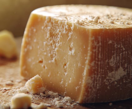 Savoring the rich texture and flavor of aged parmesan cheese on a wooden board photo
