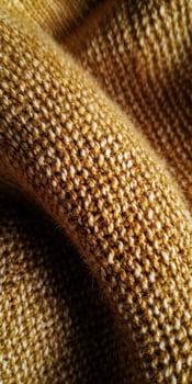 Warm textured fabric showcasing golden hues, ideal for cozy autumn clothing and home decor photo