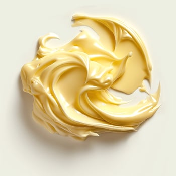 A close-up view of creamy yellow butter on a soft, neutral background. photo