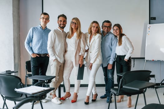 Standing and posing for a camera in the class. Group of professional business people is in the office photo