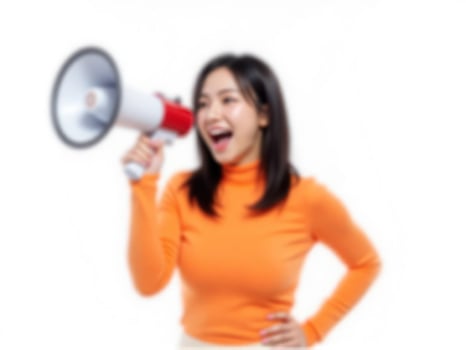 A woman is holding a megaphone and shouting photo