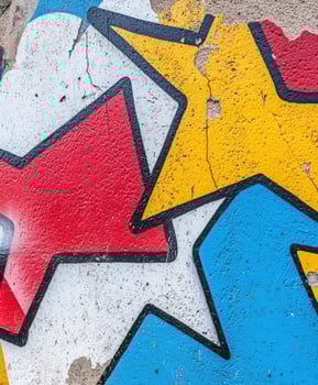 A red, yellow, and blue star on a wall photo