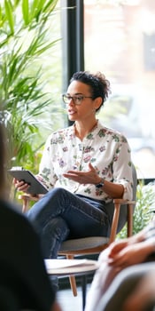 A woman is talking to a group of people photo