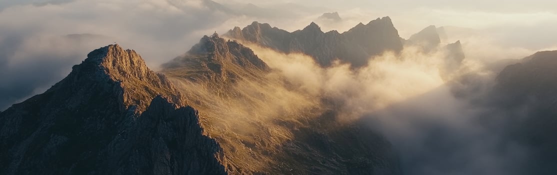 A mountain range is covered in clouds photo