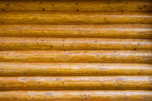 Log cabin wooden wall texture with natural wood grain and knots. photo