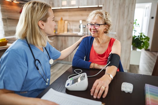 Medical checkup in a cozy home setting with a caring healthcare professional photo
