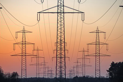 High voltage power lines over a field at sunset 2 photo