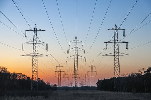 High voltage power lines over a field at sunset 3 photo