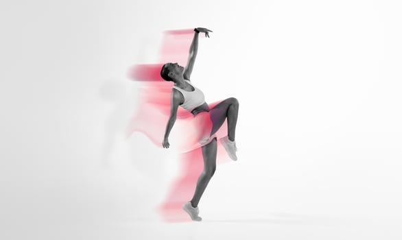 An exuberant latin young dancer in a dynamic pose captures the essence of movement and grace, set against a gradient pink and yellow background. Sport, fitness and weight loss photo