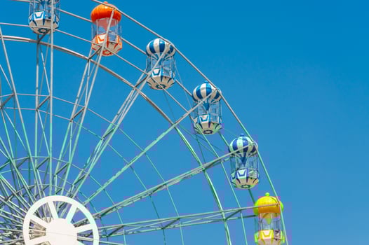 Colorful ferris wheel against a clear blue sky during a sunny day photo